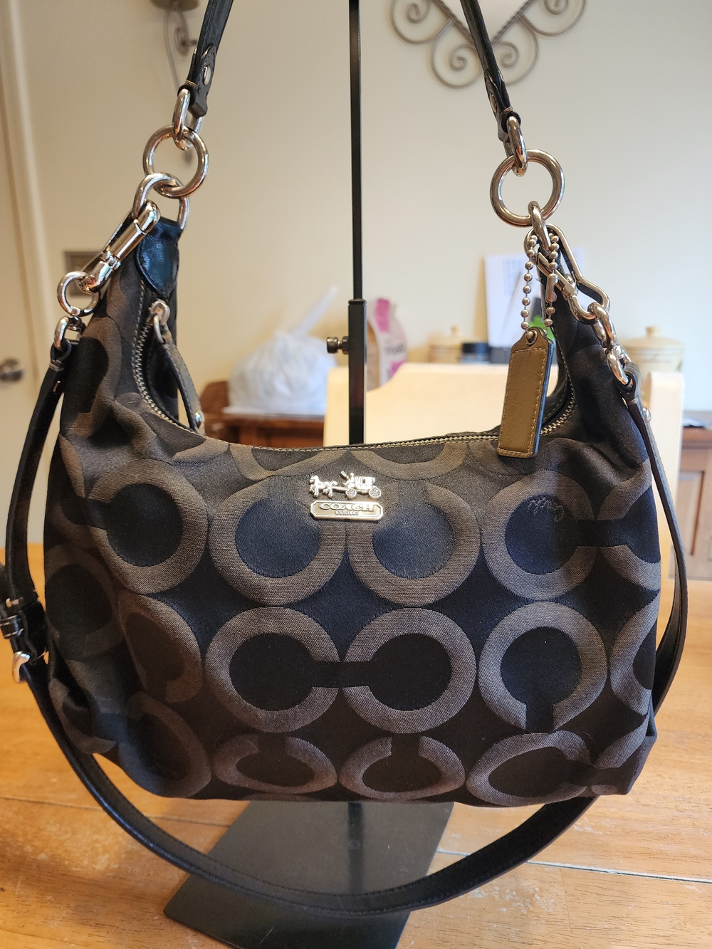 black Coach signature Op Art hobo bag featuring a repeating "C" pattern